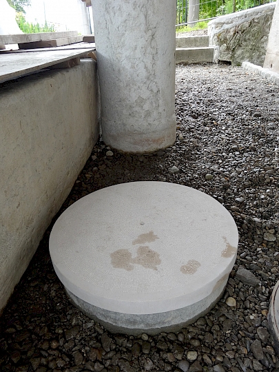 Couvercle de la vanne de purge de la chèvre en calcaire d'Hauteville bouchardé, avec coup d'outil sur le périmètre et le chant.